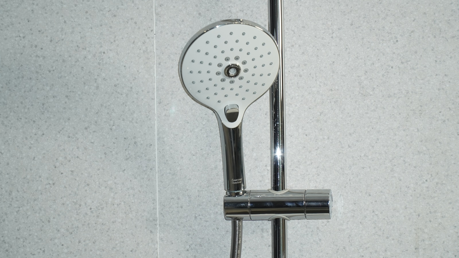 stainless steel shower head on white ceramic tiles